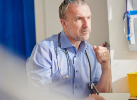 General practitioner doctor working at desk