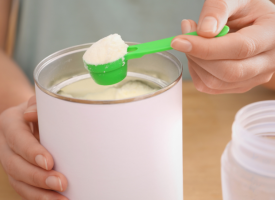 Mother scooping infant formula powder