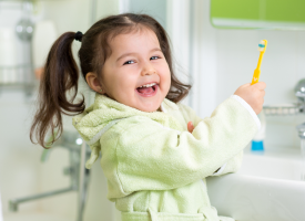 Child brushing teeth water fluoride