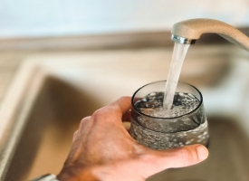 Hand filling up water glass