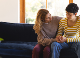 Couple consoling each other on couch
