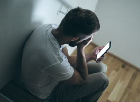 Man upset in phone in hands