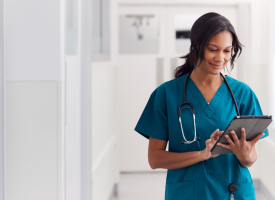 Doctor on tablet working at hospital