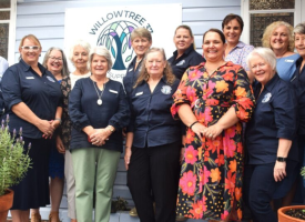 A group of smiling workers from Willowtree