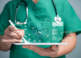 A medical professional in green scrubs holds a tablet computer and smart pencil. Computer generated information floats above the tablet computer.