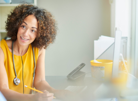 Female GP smiling in consultation room