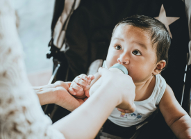Baby being fed with bottle. 
