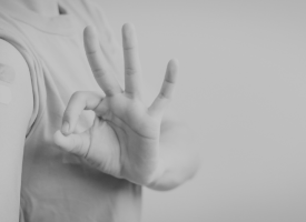 image of an arm with bandaids post vaccination