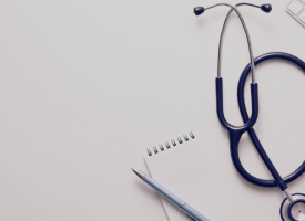 Notepad, stethoscope, and keyboard
