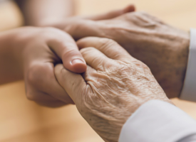 Two people holding hands