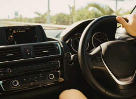 Hand using steering wheel in car