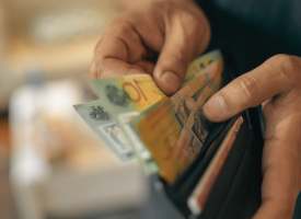 Hands going through money in wallet