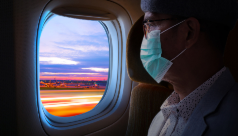 Image of passenger wearing mask in plane