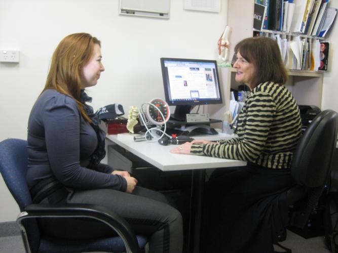 A GP in consultation with a woman.