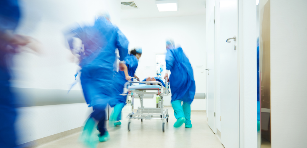 Hospital staff rushing with a gurney