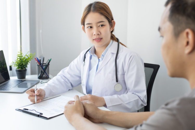 young female doctor consulting with a male patient