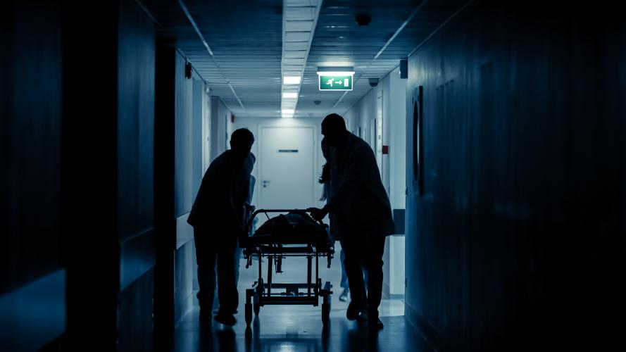 Silhouette of ED workers with stretcher 