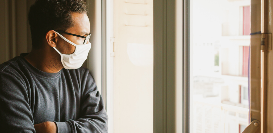 Man looking out window