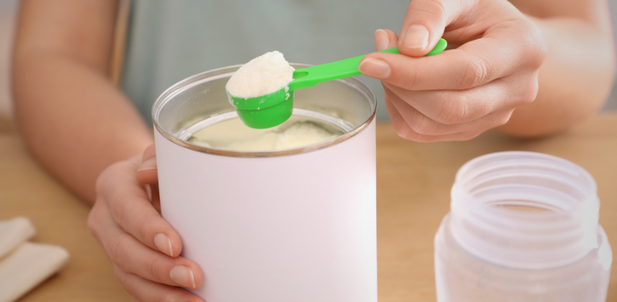Mother scooping infant formula powder