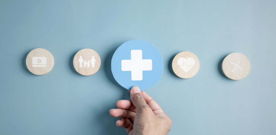 Person's hand holding plus symbol and healthcare medical icon