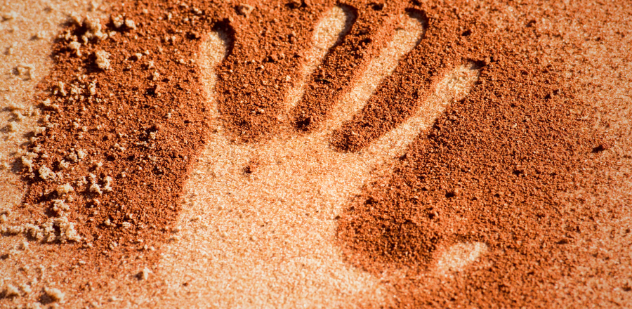 Hand print in sand