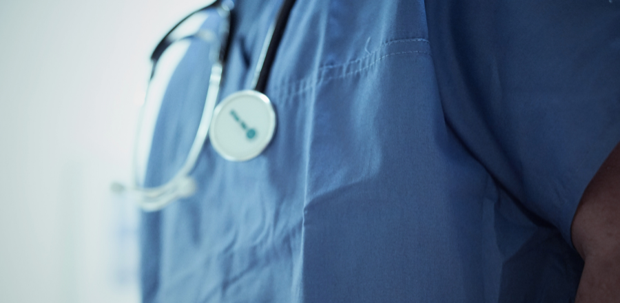 Close up of a stethoscope around a doctor's shoulders