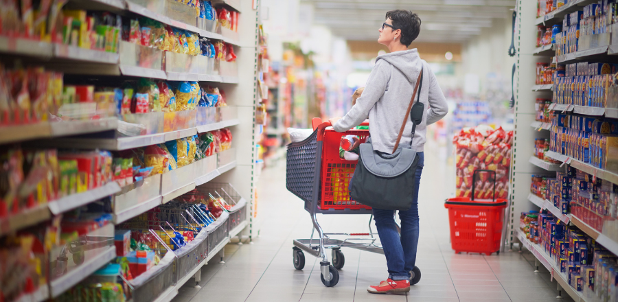 Woman shopping in supermarket aisle