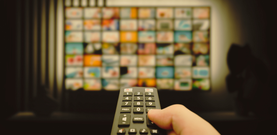 picture of someone holding remote in front of TV screen