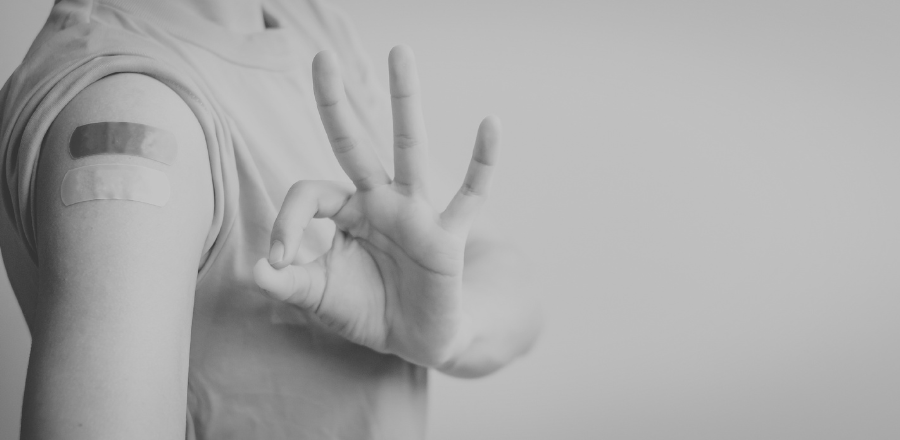 image of an arm with bandaids post vaccination