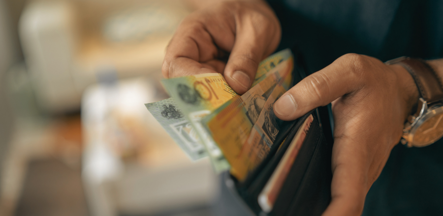 Hands flicking through money in a wallet